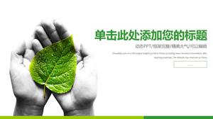 Tangan memegang templat PPT lingkungan perlindungan daun hijau