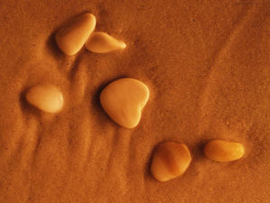 PPT background picture of pebbles lying on the sand